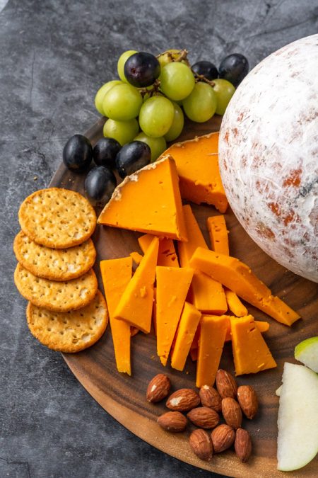 Harvest moon gourmet cheese platter with crackers, almonds and grapes. Snack cheese platter.